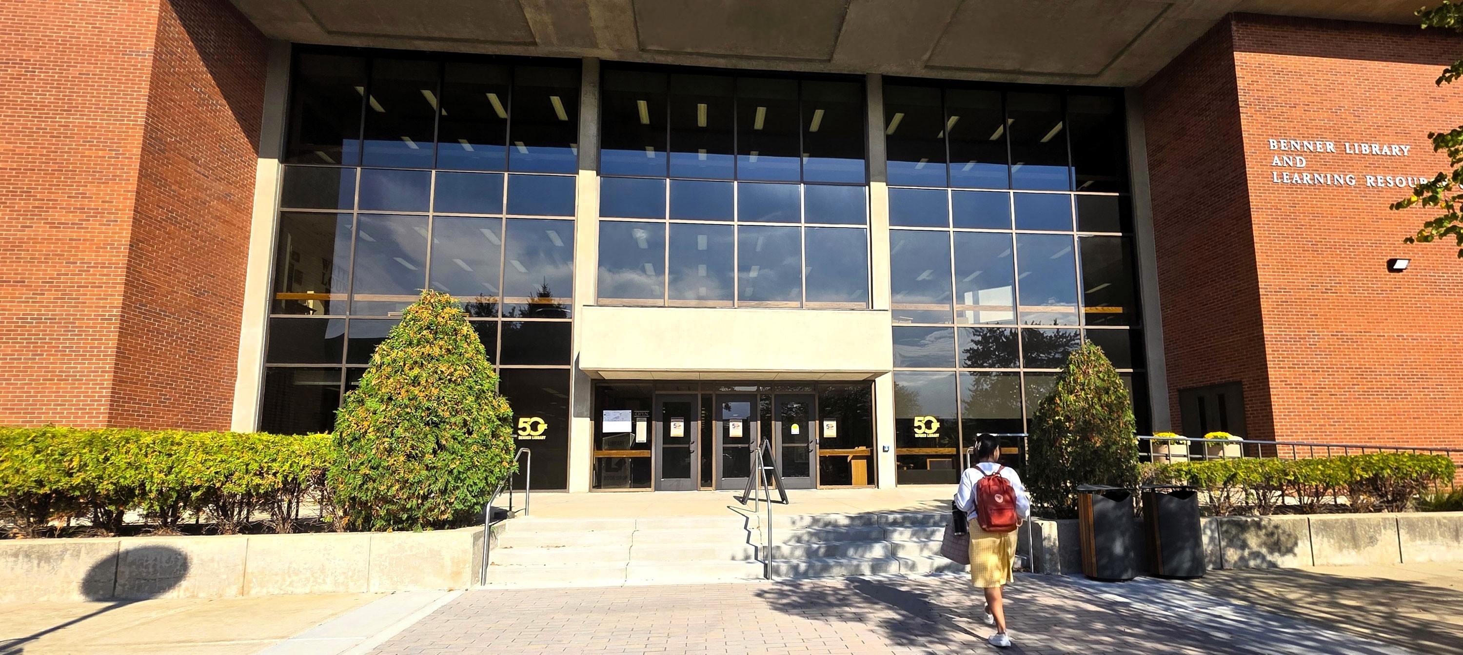Picture of student walking toward front of library